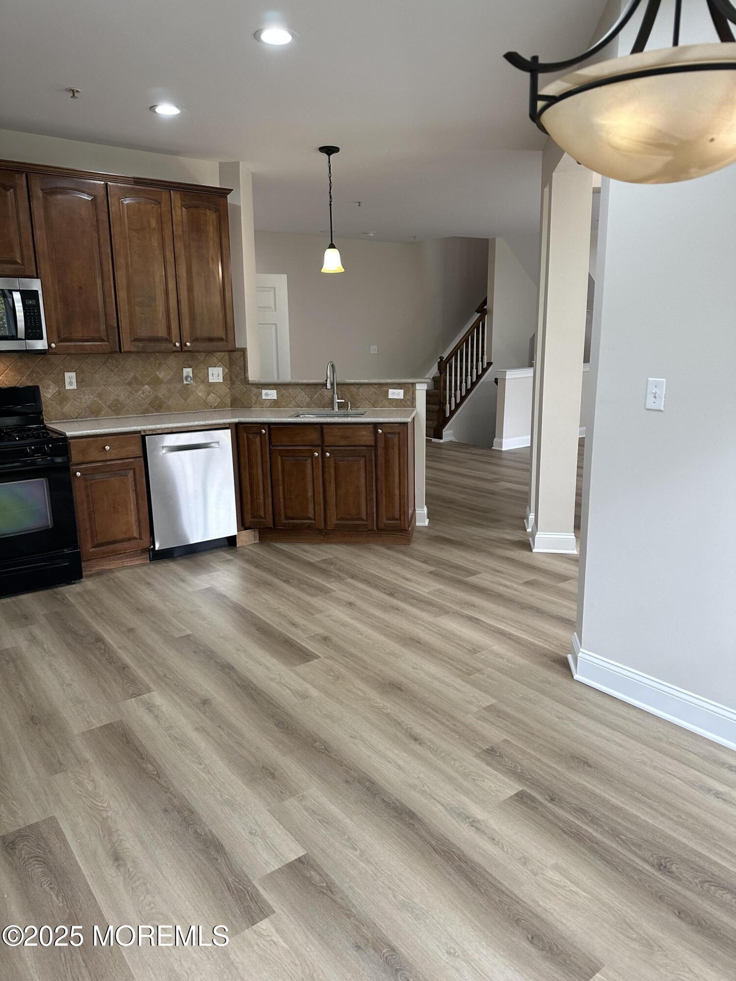 1006 Abby Road Middletown, NJ 07748 - Photo 6 of 36 a large kitchen with stainless steel appliances granite countertop a stove a sink and a refrigerator
