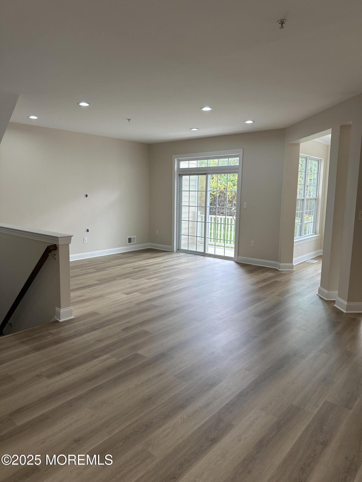 1006 Abby Road Middletown, NJ 07748 - Photo 10 of 36 a view of an empty room with wooden floor and a window