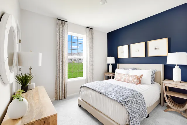 a bedroom with a bed and a potted plant