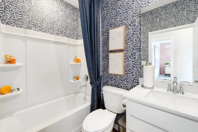 a bathroom with a sink toilet and shower