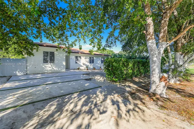 a view of a house with a tree in front