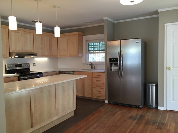 a kitchen with stainless steel appliances a refrigerator sink and microwave