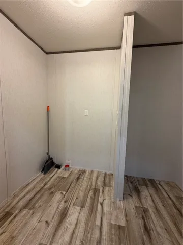 a view of a room with wooden floor