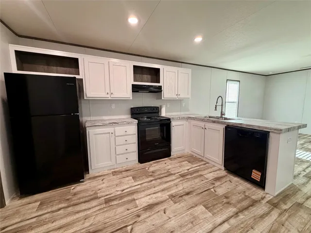 a kitchen with a refrigerator stove and sink