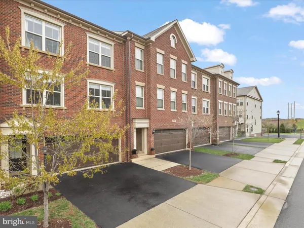 a view of a brick building next to a yard