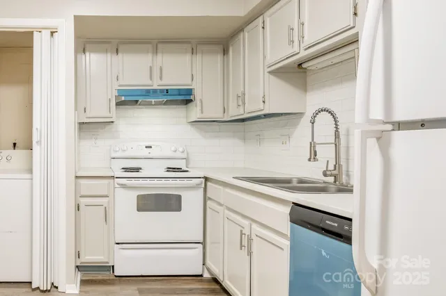 a kitchen with stainless steel appliances granite countertop a sink and a stove