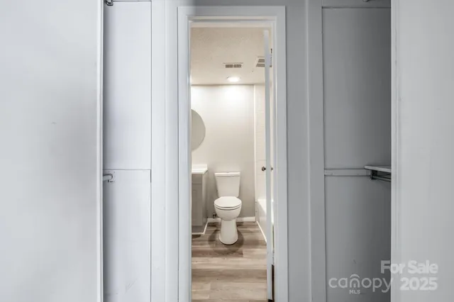 an empty room with a window and a ceiling fan