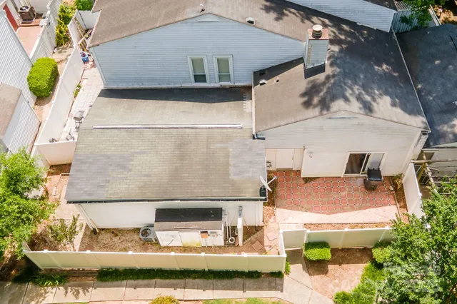 an aerial view of residential house with outdoor space and trees all around