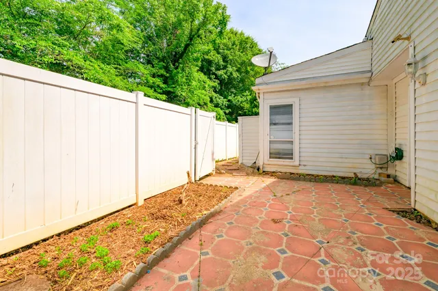 a view of a livingroom with wooden floor and a ceiling fan