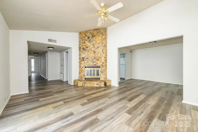 a view of a room with wooden floor