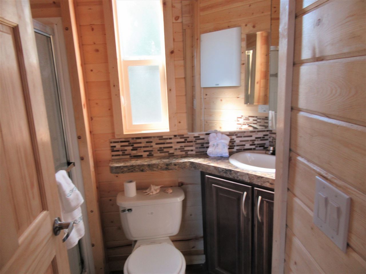 793 22 Road, Unit 67 Grand Junction, CO 81505 - Photo 11 of 14 a bathroom with a granite countertop toilet sink and mirror