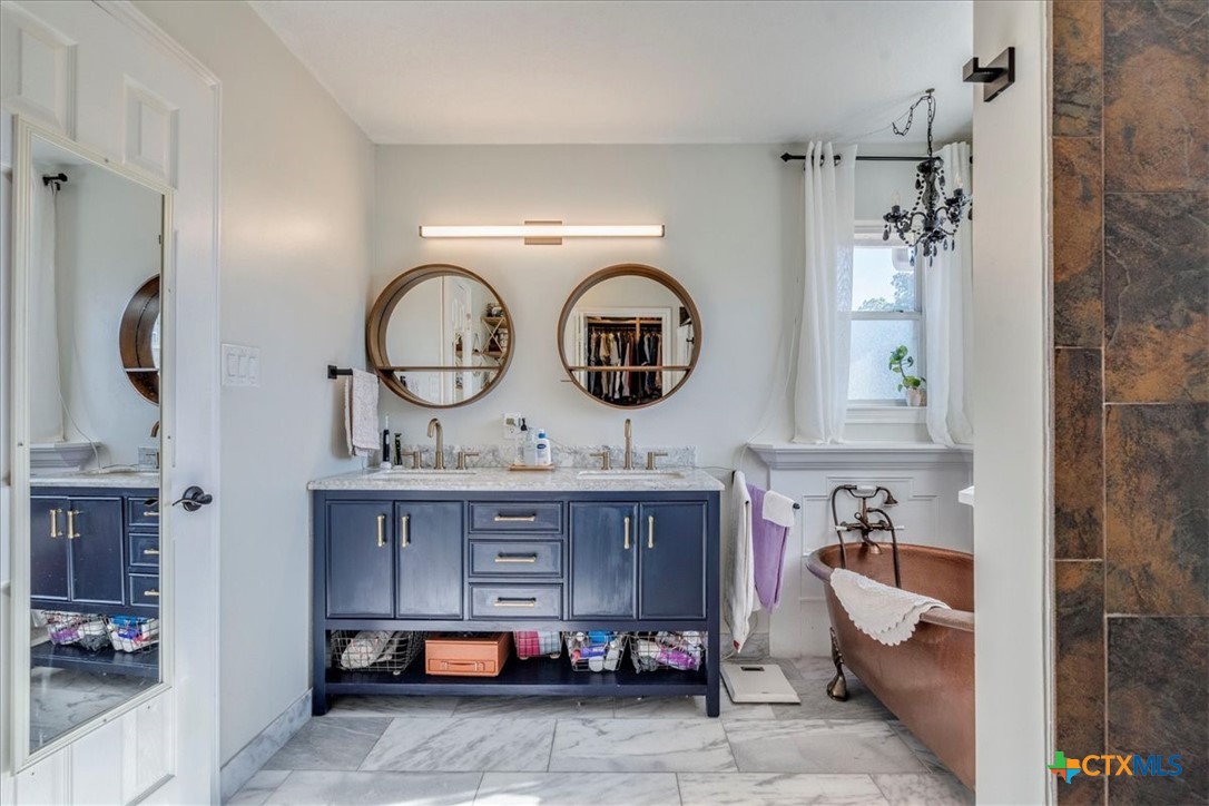 171 Pin Oak Crossing Elgin, TX 78621 - Photo 22 of 38 a bathroom with a sink and a mirror