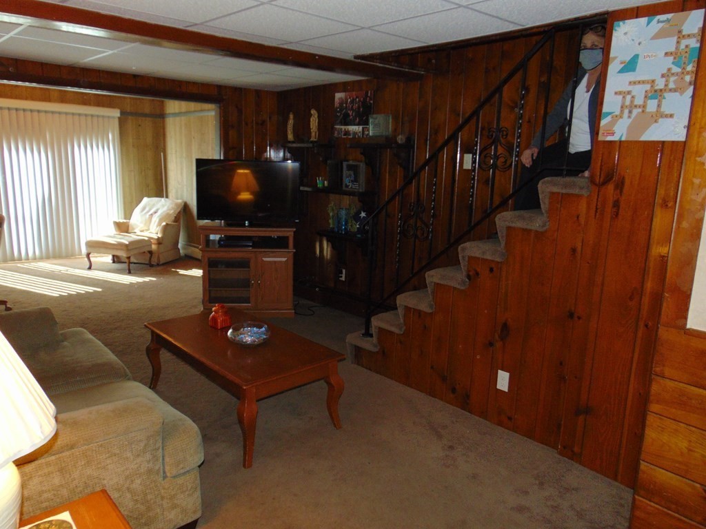 286 Riverside Drive Tiverton, RI 02878 - Photo 17 of 38 a living room with couches bookshelf and a flat screen tv