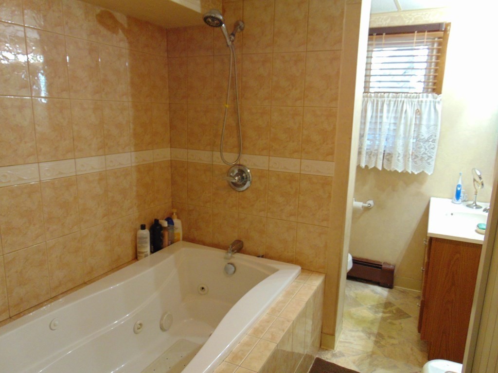 286 Riverside Drive Tiverton, RI 02878 - Photo 21 of 38 a bathroom with a tub a sink and a shower