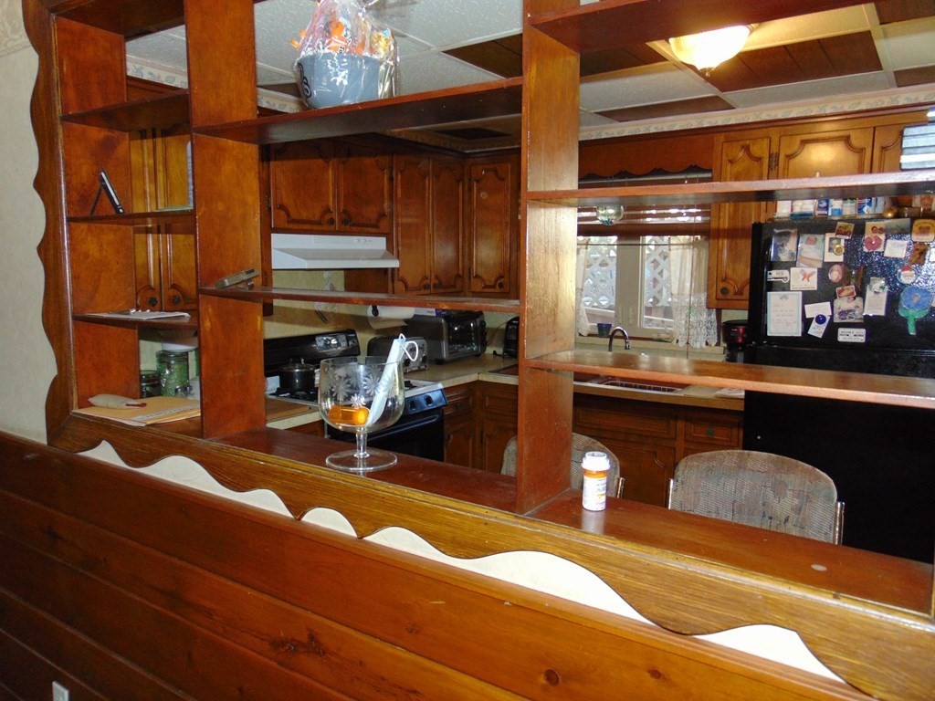 286 Riverside Drive Tiverton, RI 02878 - Photo 26 of 38 a kitchen with a refrigerator and a sink