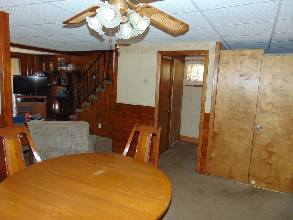 286 Riverside Drive Tiverton, RI 02878 - Photo 27 of 38 a bedroom with a bed and a chandelier