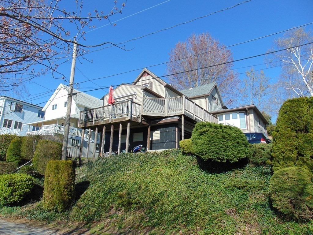 286 Riverside Drive Tiverton, RI 02878 - Photo 3 of 38 a view of a big house with a big yard and potted plants