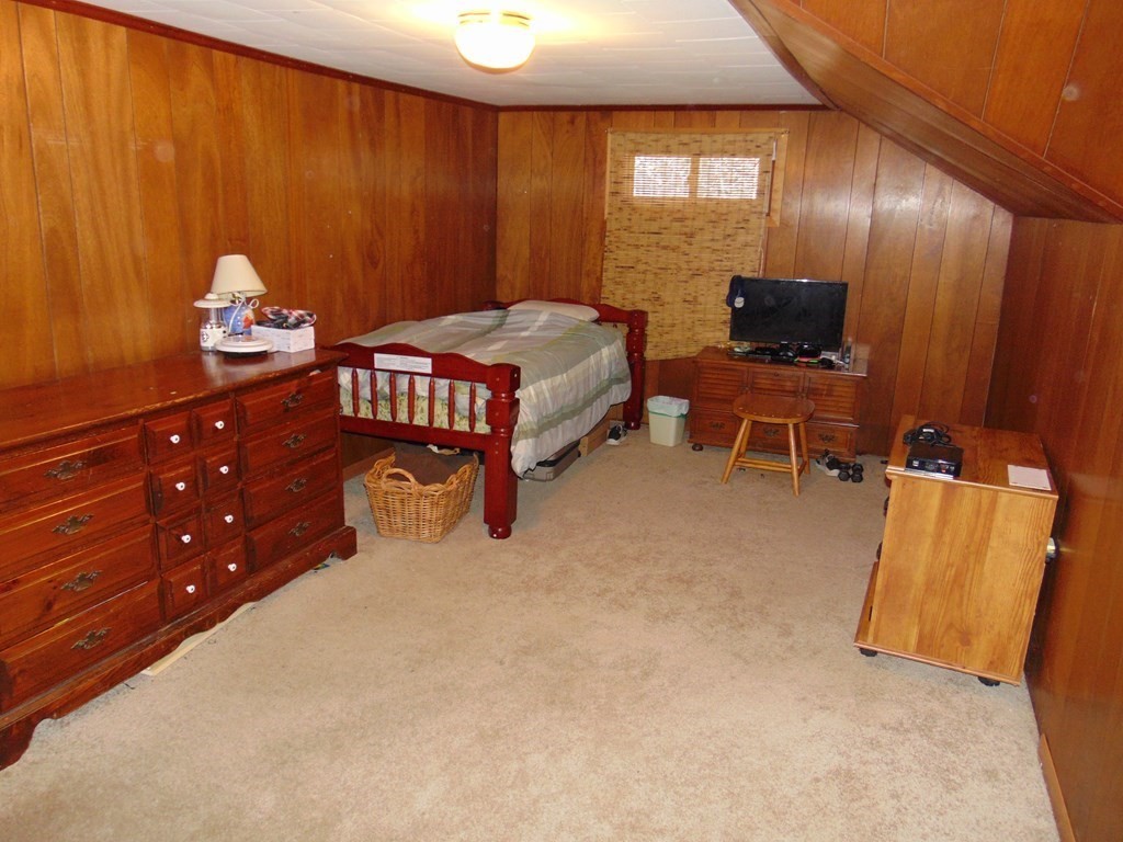 286 Riverside Drive Tiverton, RI 02878 - Photo 31 of 38 a bedroom with a bed and a tv in it