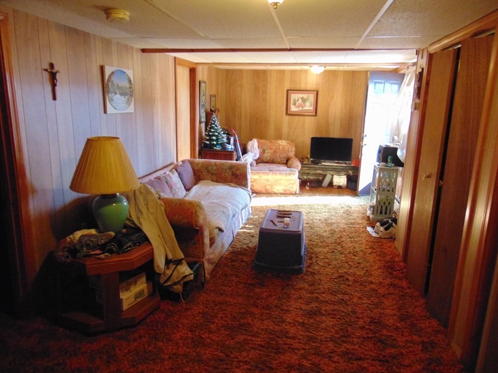 286 Riverside Drive Tiverton, RI 02878 - Photo 32 of 38 a living room with furniture and a flat screen tv