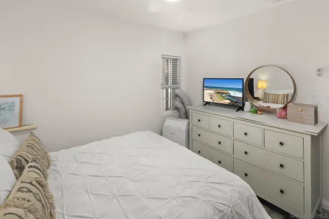 a bedroom with a bed and a flat screen tv