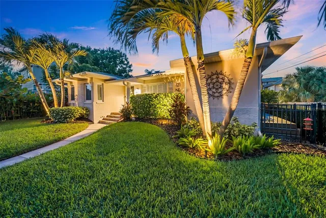 a living room with lots of furniture and kitchen view