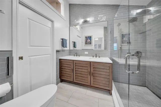 a bathroom with a sink a toilet and shower