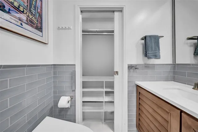 a bedroom with a bed and painting on the wall