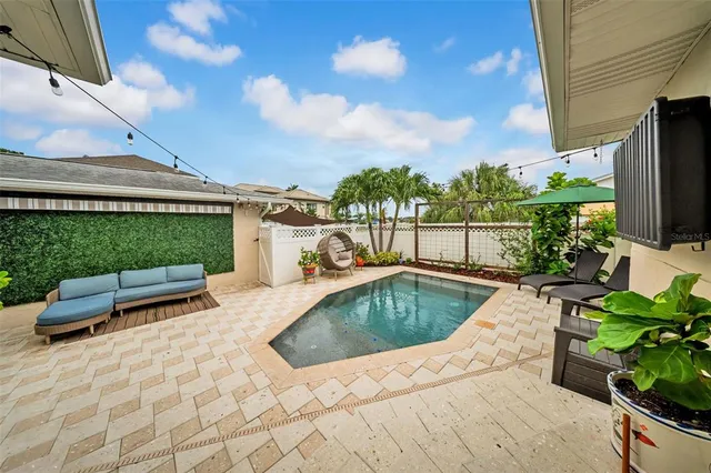 a view of a patio with couches and potted plants