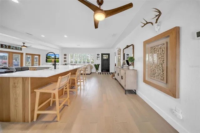 a living room with furniture a large window and a flat screen tv
