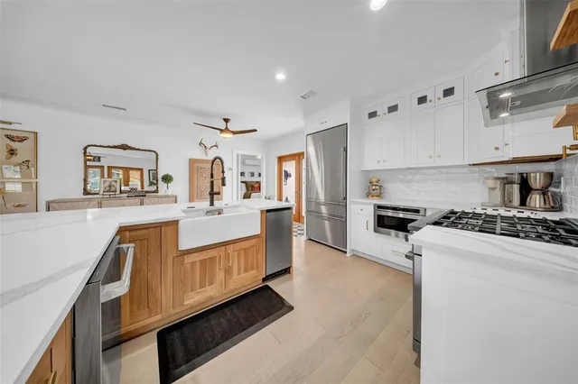 a kitchen with a stove top oven and cabinets