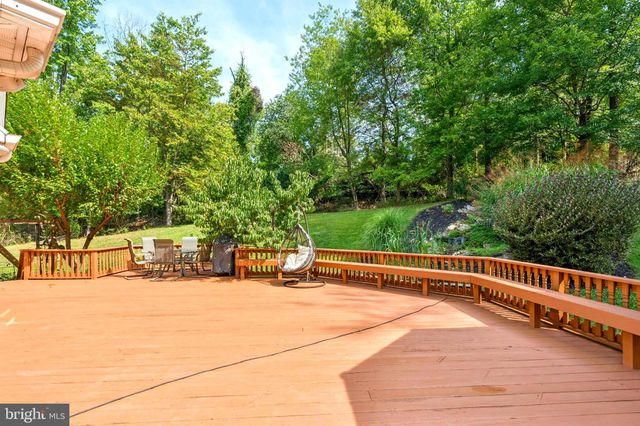a living room with stainless steel appliances granite countertop furniture a large window and wooden floor