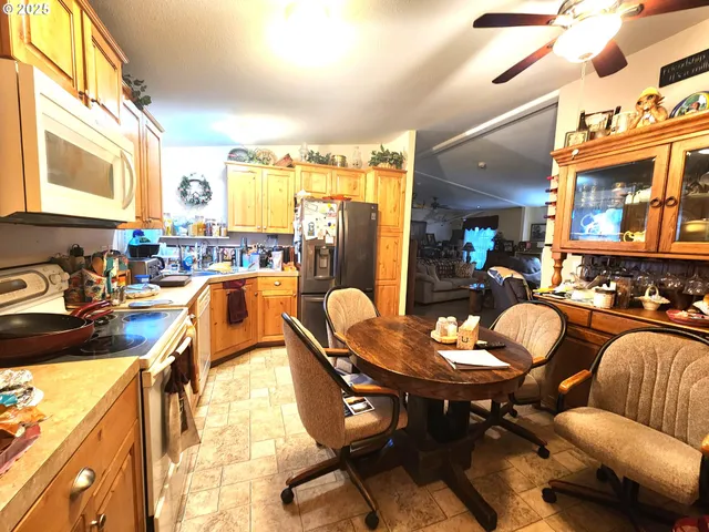 a kitchen with a table chairs stove and refrigerator