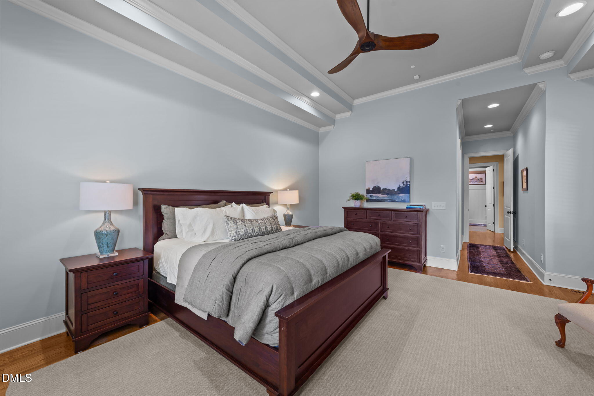 1859 Versa Court Apex, NC 27502 - Photo 14 of 46 a bedroom with a bed and dresser with mirror