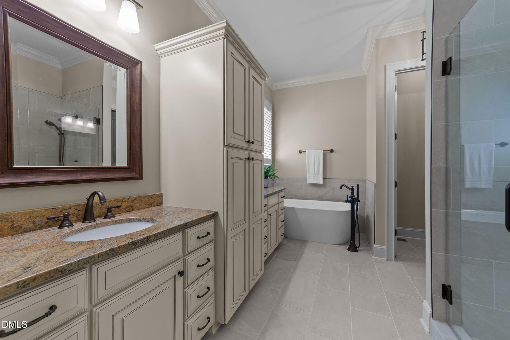 1859 Versa Court Apex, NC 27502 - Photo 15 of 46 a bathroom with a double vanity sink toilet mirror and bathtub