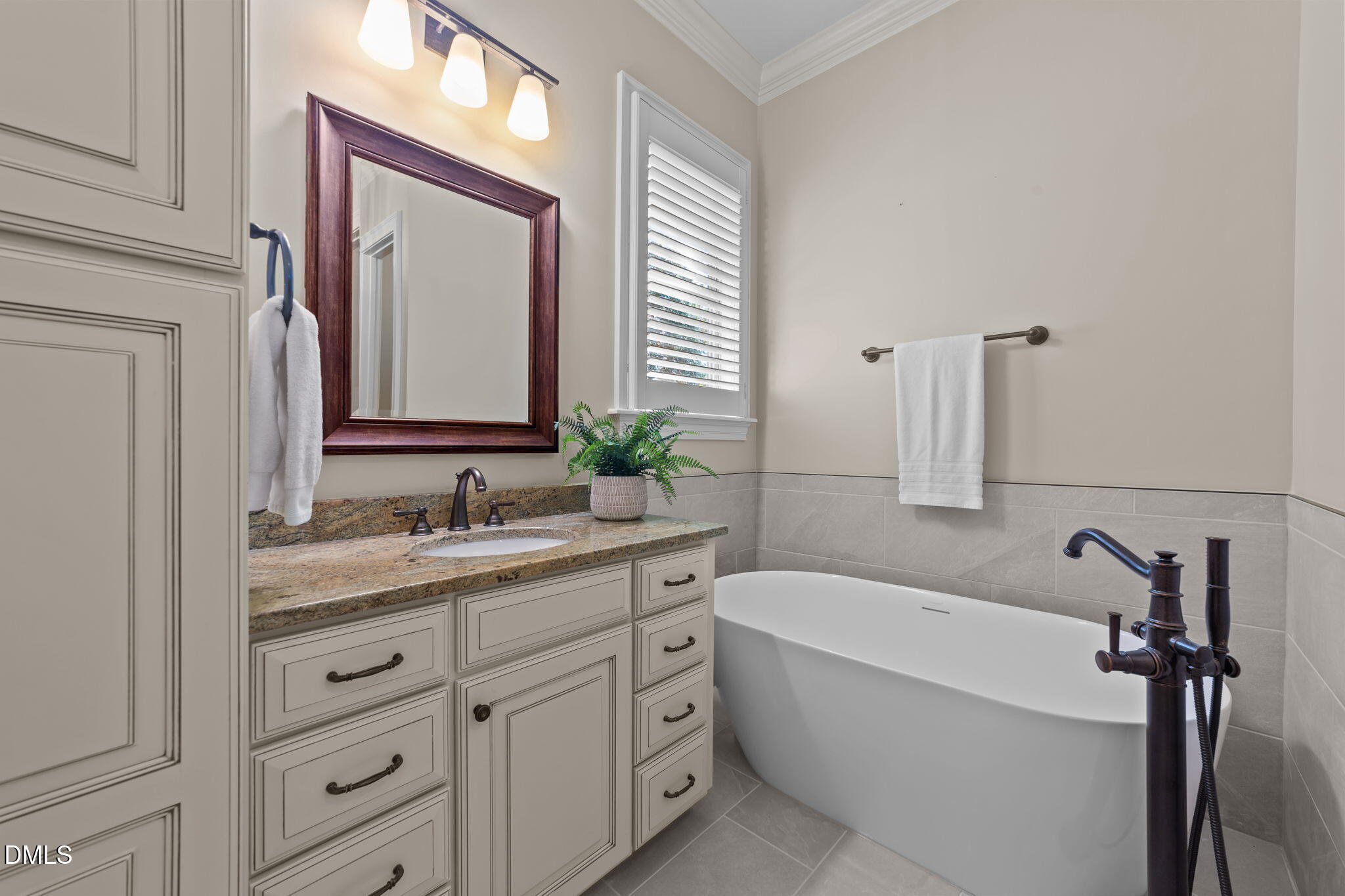 1859 Versa Court Apex, NC 27502 - Photo 16 of 46 a bathroom with a granite countertop sink tub and a mirror