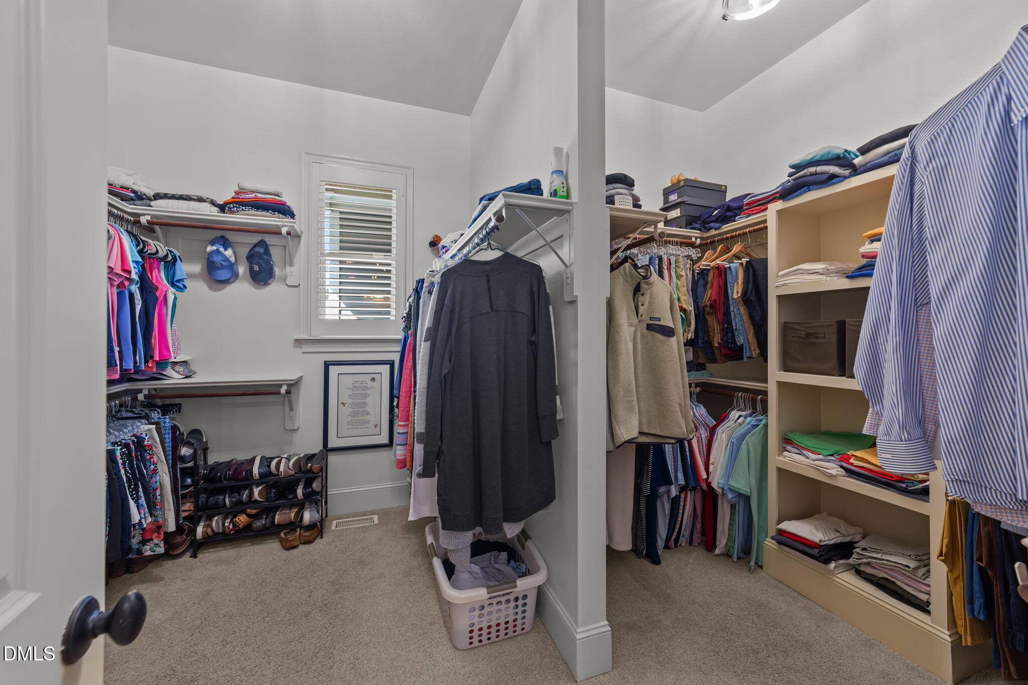1859 Versa Court Apex, NC 27502 - Photo 18 of 46 a view of walk in closet with clothes and shoes