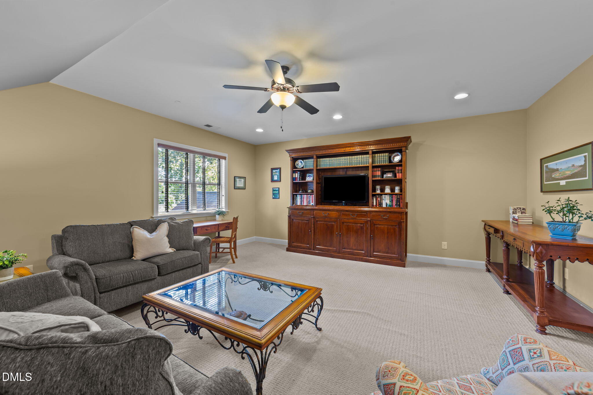 1859 Versa Court Apex, NC 27502 - Photo 32 of 46 a living room with furniture and a flat screen tv