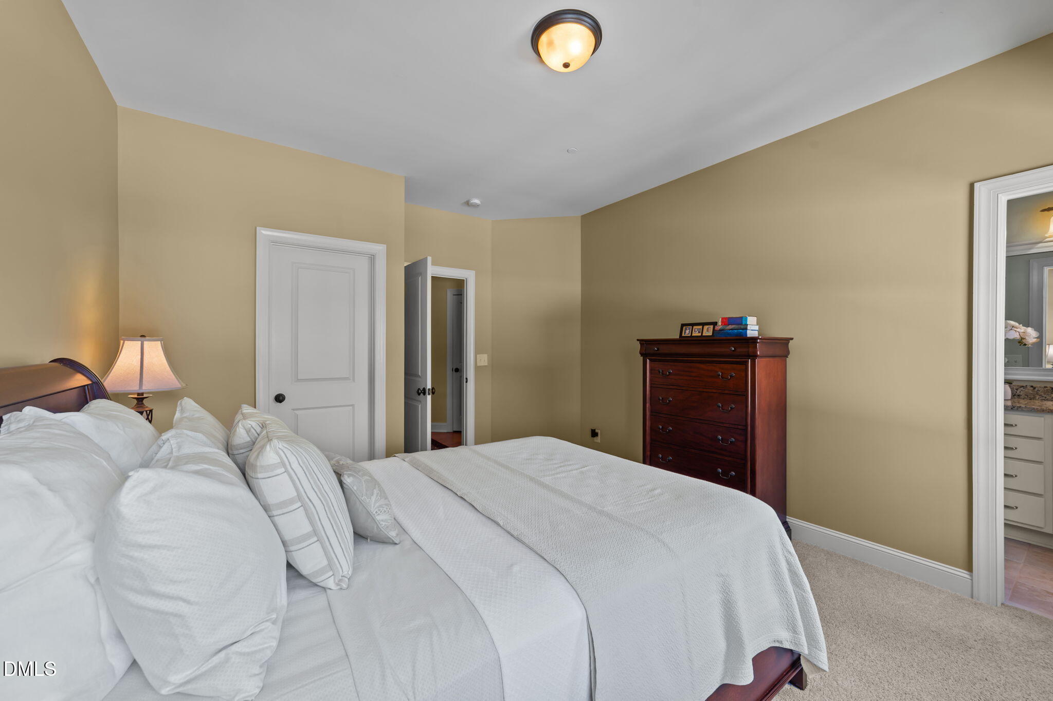 1859 Versa Court Apex, NC 27502 - Photo 34 of 46 a bedroom with a bed and a dresser