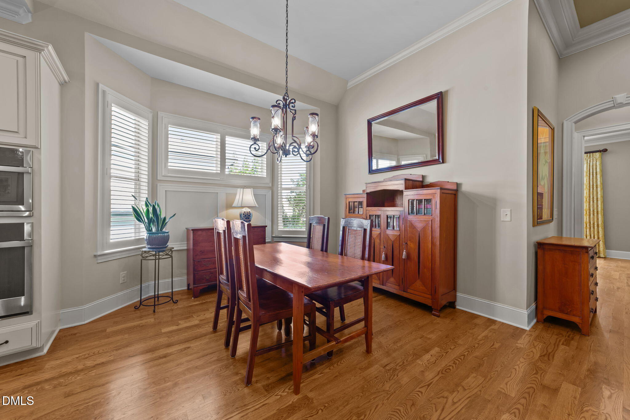 1859 Versa Court Apex, NC 27502 - Photo 9 of 46 a view of a dining room with furniture window and wooden floor