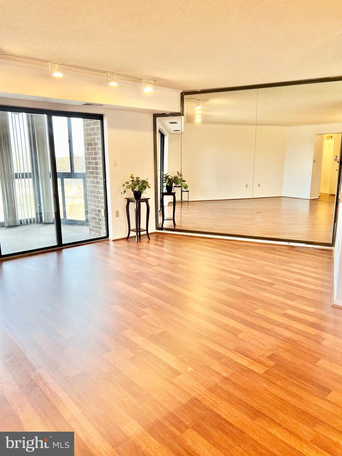 15115 Interlachen Drive, Unit 3603 Silver Spring, MD 20906 - Photo 12 of 49 a view of an empty room with wooden floor and a window