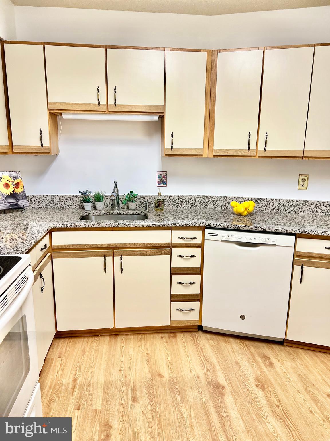 15115 Interlachen Drive, Unit 3603 Silver Spring, MD 20906 - Photo 17 of 49 a kitchen with granite countertop a sink a stove and cabinets