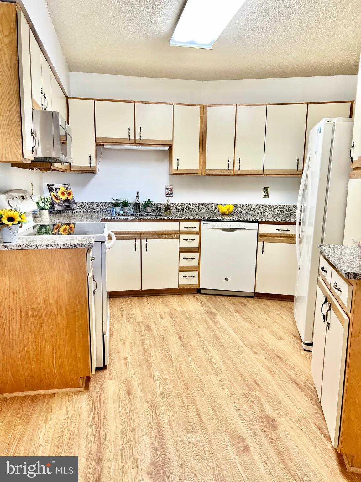 15115 Interlachen Drive, Unit 3603 Silver Spring, MD 20906 - Photo 3 of 49 a kitchen with stainless steel appliances granite countertop a stove a sink and a refrigerator