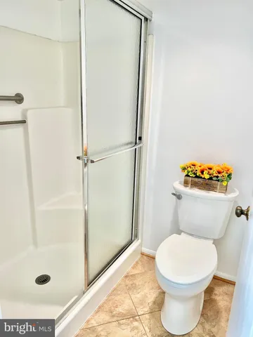 a white toilet sitting next to a bathroom sink