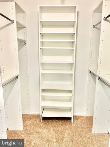 a view of closet area with empty racks