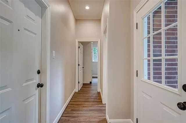 a bathroom with a granite countertop sink a large mirror and a bathtub