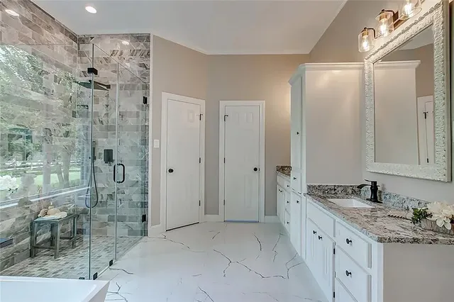 a large kitchen with kitchen island a sink stainless steel appliances and cabinets