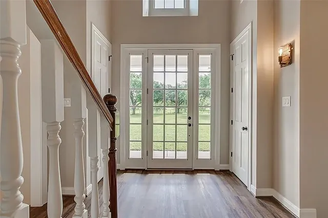 a view of an entryway with wooden floor and door