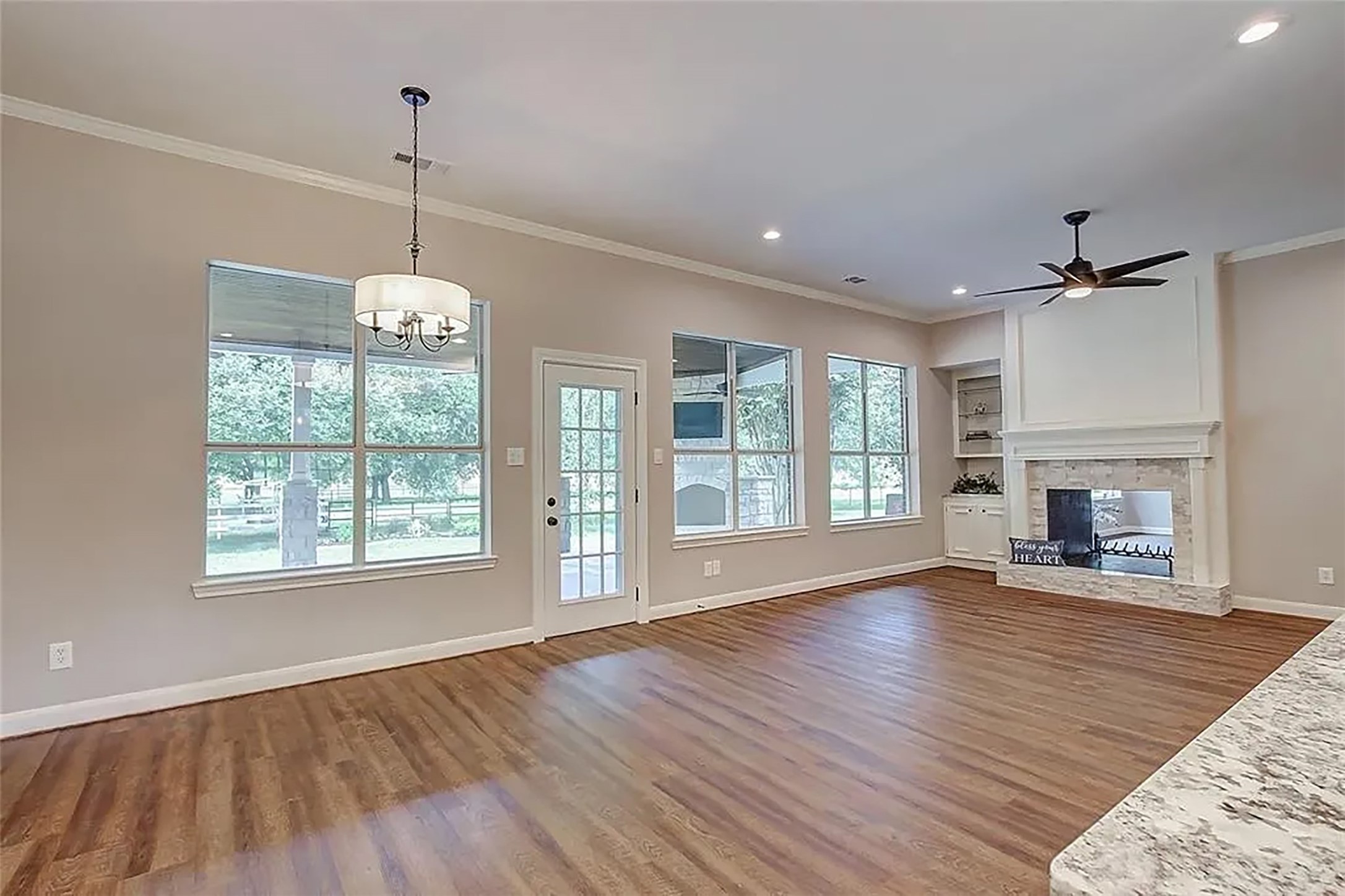 4421 Bowser Road Fulshear, TX 77441 - Photo 23 of 41 a view of an empty room with wooden floor fireplace and a window