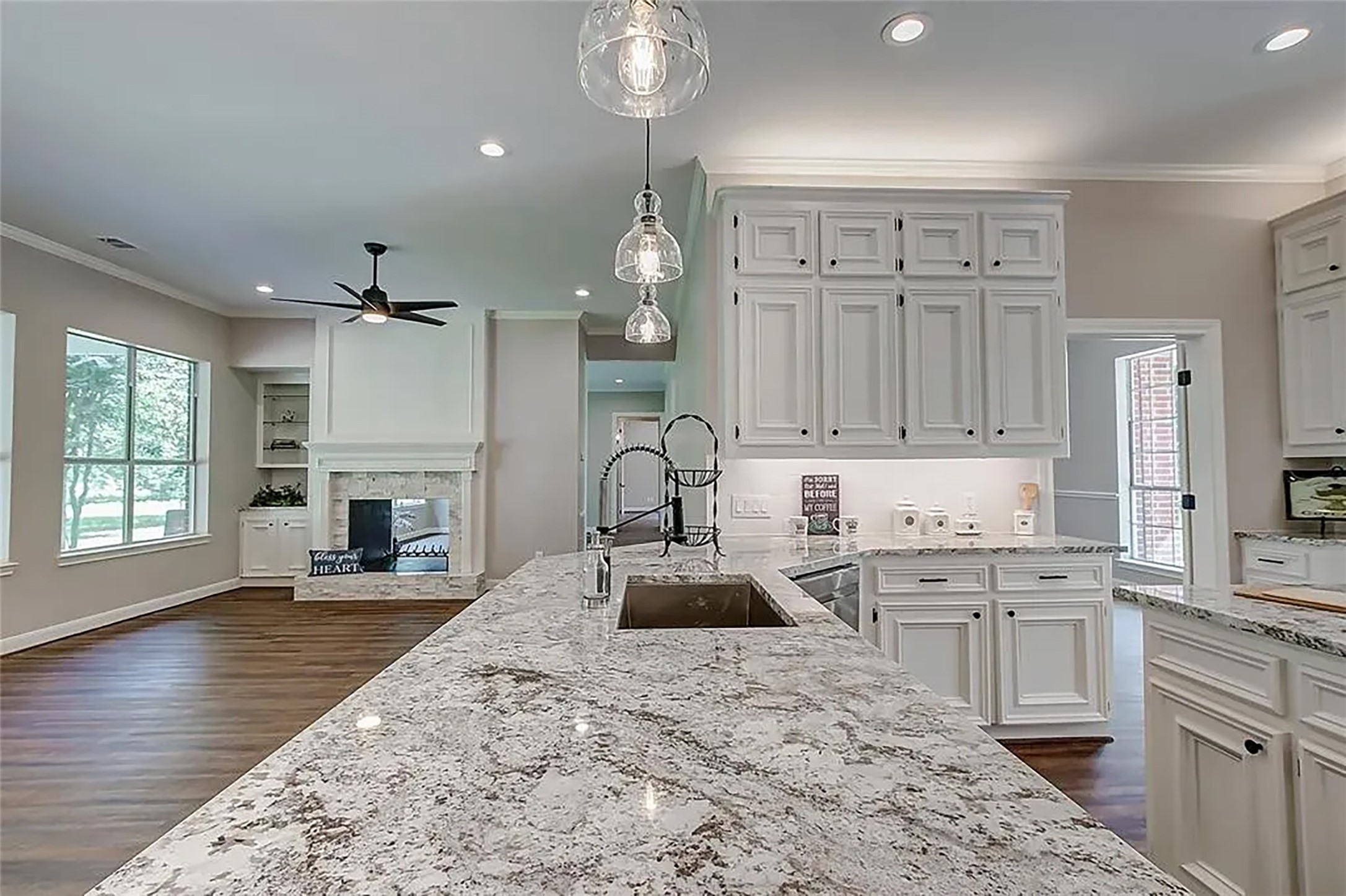4421 Bowser Road Fulshear, TX 77441 - Photo 24 of 41 a large kitchen with kitchen island a sink stainless steel appliances and cabinets