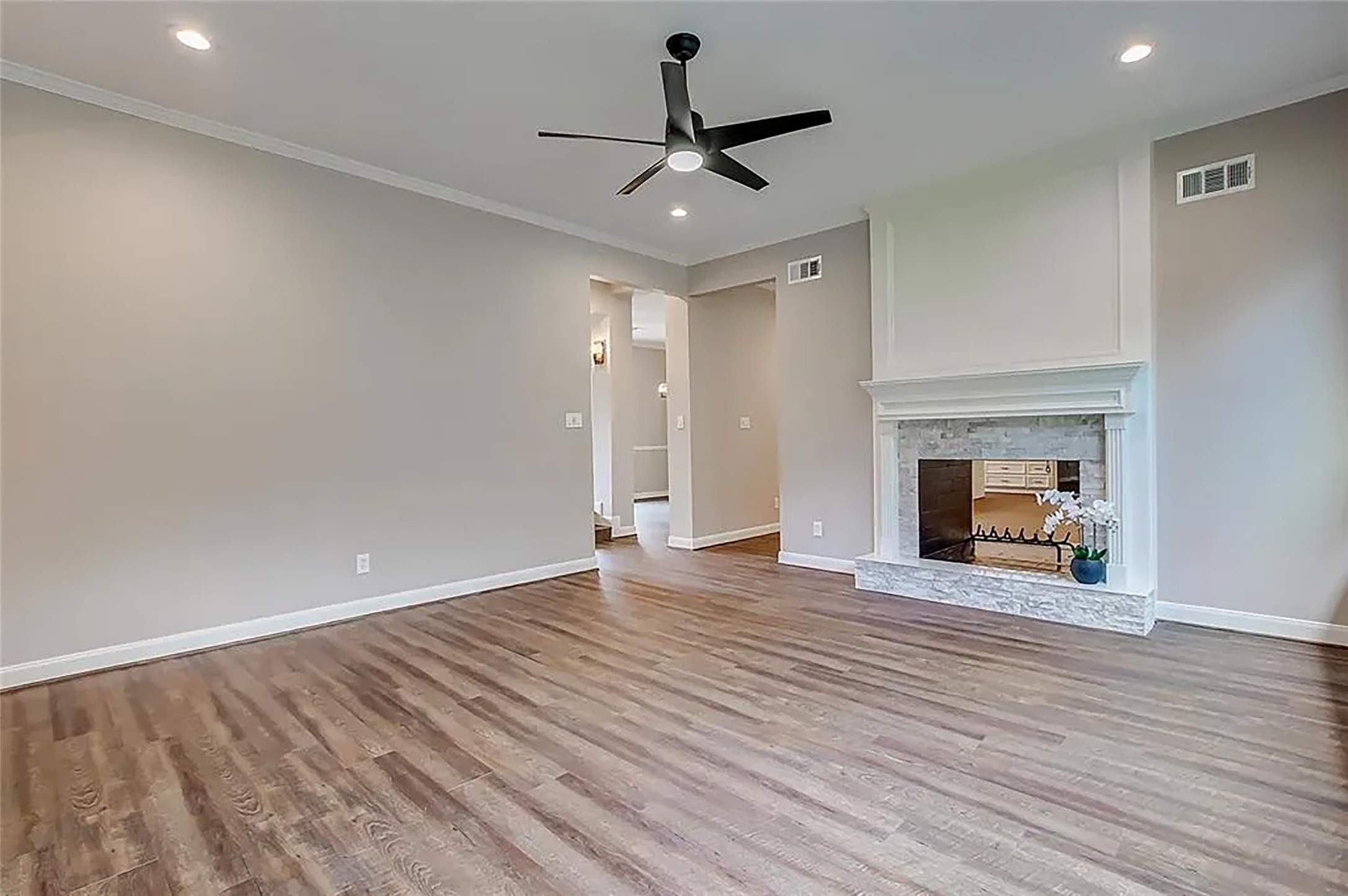 4421 Bowser Road Fulshear, TX 77441 - Photo 28 of 41 a view of an empty room with wooden floor a fireplace and a window
